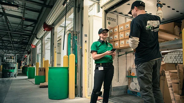 Warehouse_Dock_Forklift_Driver_Worker_Phone_Smiling_600x338.jpg